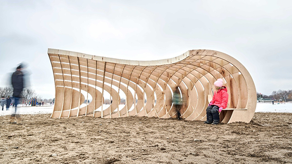 Experience Winter Art at Toronto's Woodbine Beach 2 Crest emerges from sand snow resembling sweeping wave poised just before crashing inviting visitors for shared fleeting moment like wave hitting shore.