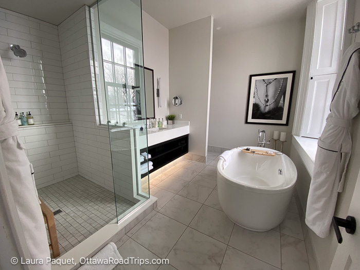 frontenac suite bathroom - Ottawa Road Trips bathroom with large walk-in shower, oval standalone tub, long white vanity with big mirror