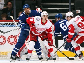 Albert Johansson of the Red Wings defends against Ryan Reave