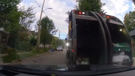 London garbage truck crashes into vehicle