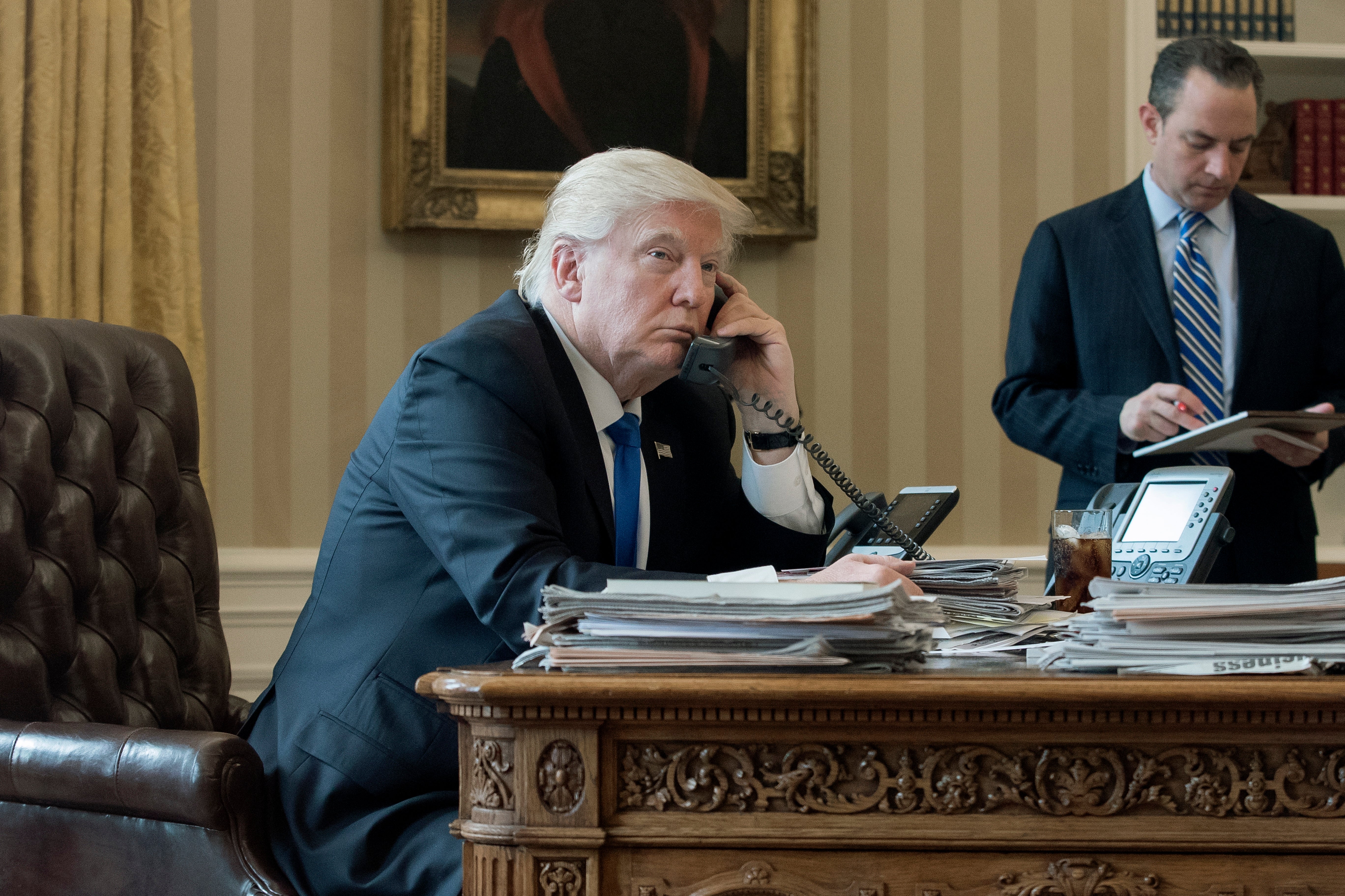 Trump speaks on phone in the Oval Office of the White House in Washington, DC, on January 28 2017. Trump is now making calls to GOP senators to pressure them to approve Gaetz for attorney general