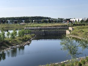 A wide photo of Lake Siagon - a stormwater pond in Mississauga - water and trees