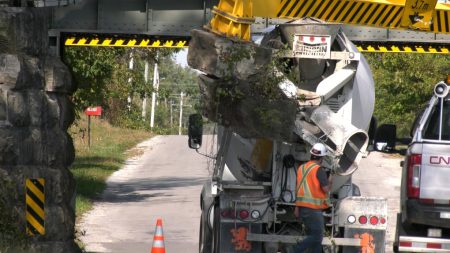 Truck wedged beneath CN train bridge