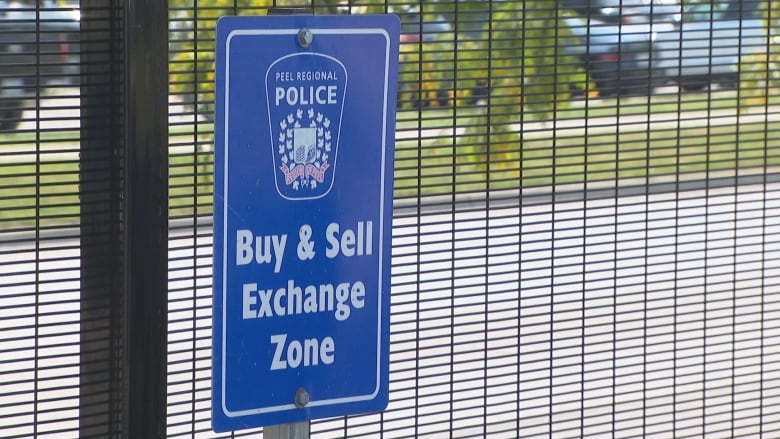 Photo of a sign reading: Buy & Sell Exchange Zone.