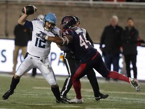 Toronto Argonauts quarterback Chad Kelly, left, is tackled by Montreal Alouettes defensive end Jordan Domineck during third quarter CFL Eastern Conference Final football action Saturday, Nov. 9, 2024 in Montreal.