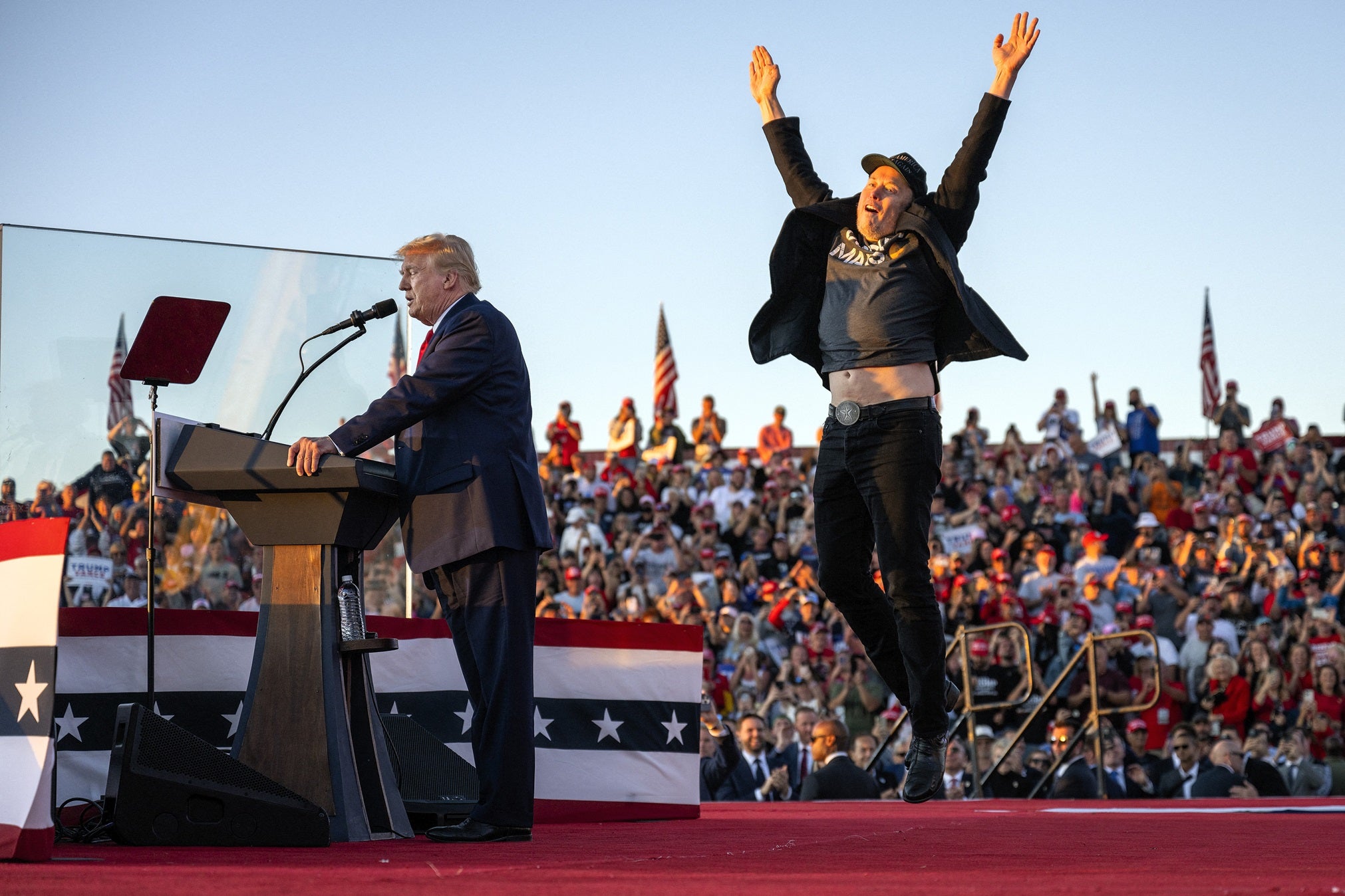 Elon Musk jumps on stage as he joins Donald Trump during a campaign rally, 5 October