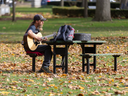 Jeffery Ormston plays guitar in Victoria Park in London on Monday, Nov. 4, 2024. “I’m just noodling out here because it’s one of the last nice days we’re going to get,” he said. (Derek Ruttan/The London Free Press)