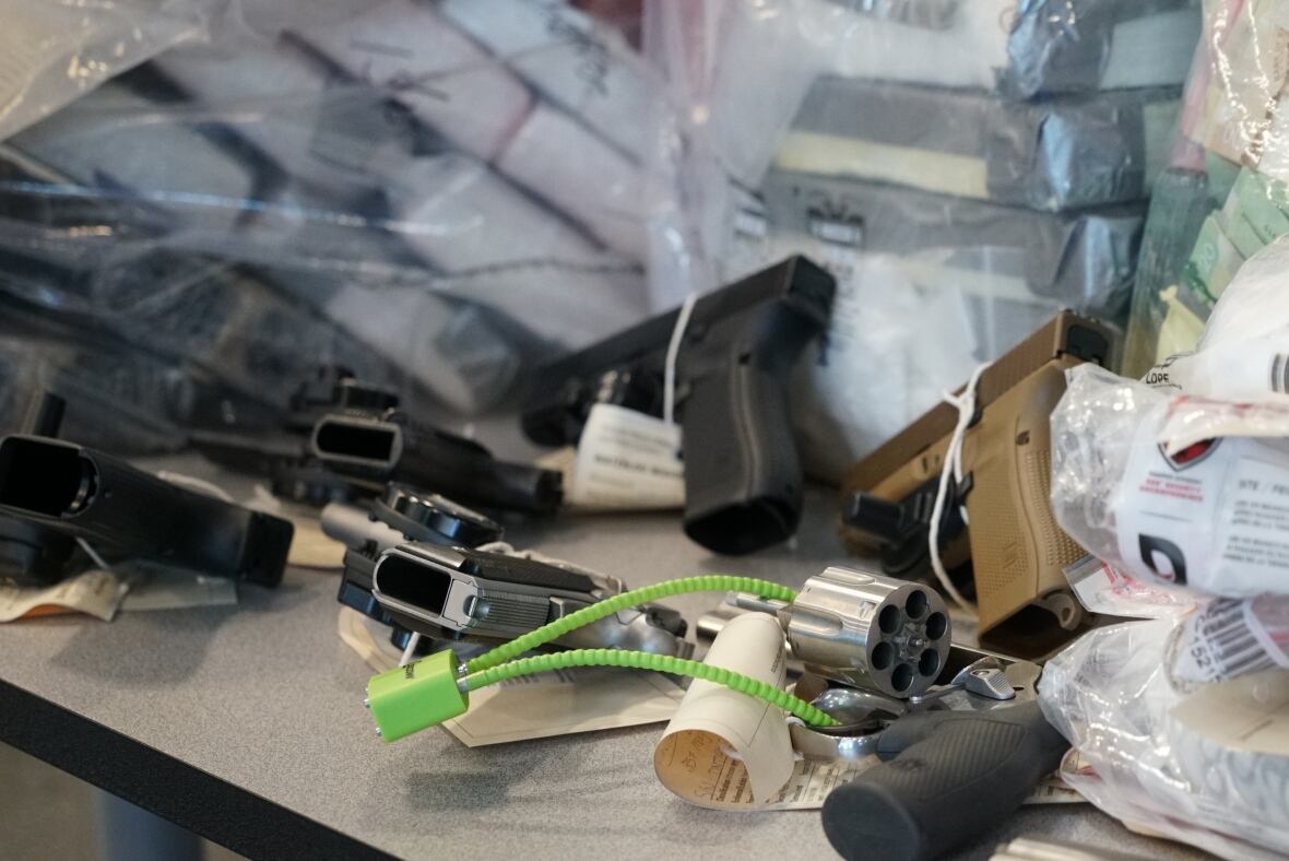 A photo of some firearms on a table.