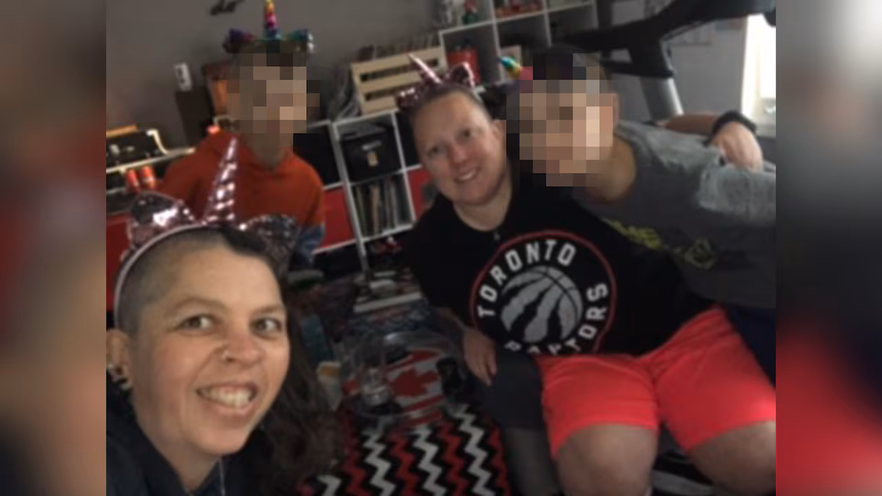 two women, two boys smiling