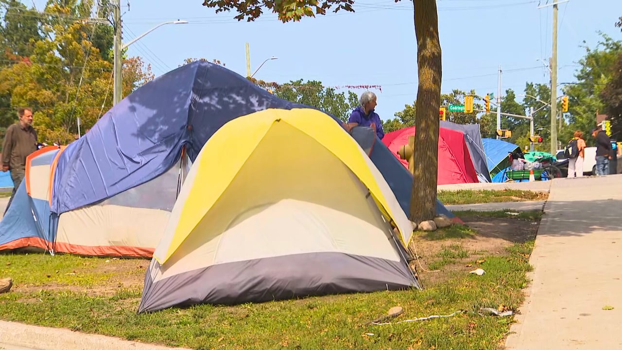 Tents line a city street. 