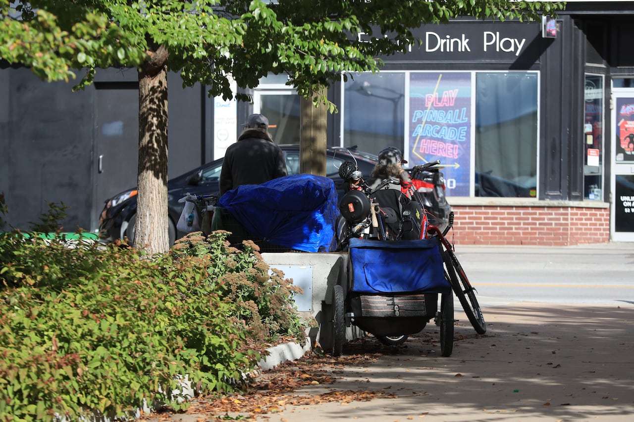 A man with his belongings alongside Memorial Square downtown Barrie, Ont., on the morning of Thursday, October 12, 2023. THE CANADIAN PRESS/Christopher Drost