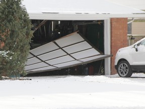 A Sarnia man drove through his garage on Cathcart Boulevard Jan. 1 and crashed in front of a neighbour's house, the neighbour says.