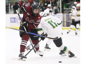 Chatham Maroons' Dylan Richter (18) tries to get past St. Thomas Stars' Rory Savage (11) at Chatham Memorial Arena in Chatham, Ont., on Sunday, Jan. 18, 2026.