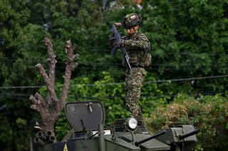 A Colombian soldier stands on top of a military vehicle at border crossing with Venezuela located Cucuta Colombia January third twenty twenty six