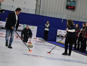Craig Beck of Port Elgin Chrysler delivered the ceremonial rock at Jan.23 opening of Port Elgin Chrysler 23 Ontario Tankard and Scotties. He got encouragement from Maggie Tieman of Bruce Power (centre) while being swept by Saugeen Shores deputy mayor Diane Huber (right)and Saugeen First Nation Chief Conrad.