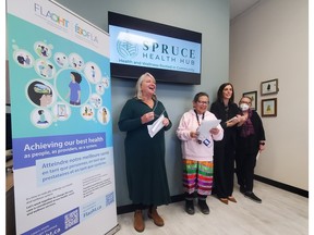 four women stand for photo