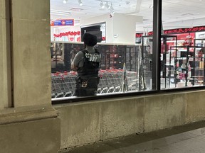 Theft Rates Surge in Kingston Since Pandemic 1 A security guard standing at a store entrance