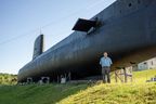 Ian Raven stands in front of the newly painted HMCS Ojibwa in Port Burwell in this file photo. (Free Press files)