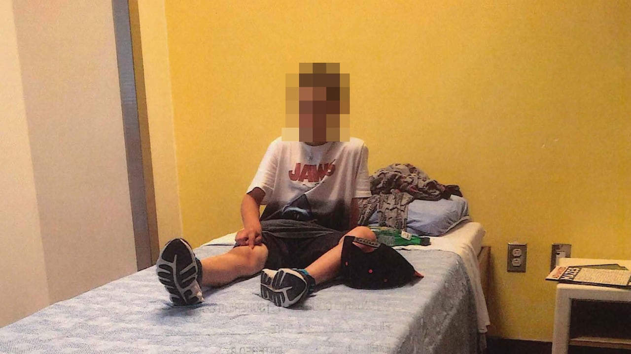 boy sits on bed 