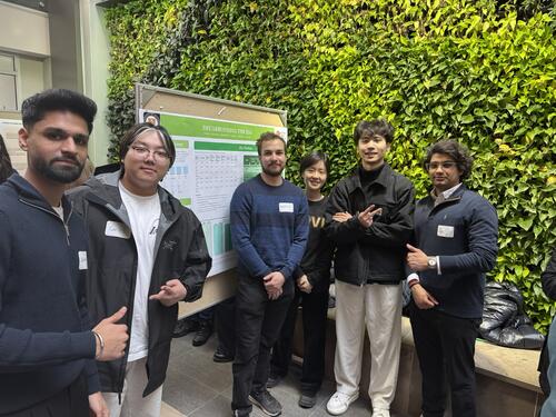 Students beside capstone poster.