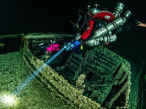 scuba diver explores shipwreck