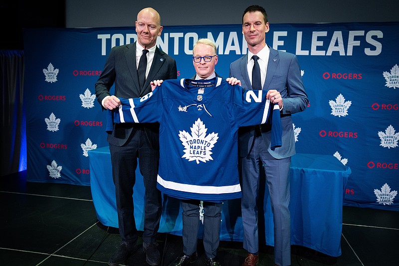 New Toronto Maple Leafs Senior Executive Advisor Hockey Operations Mats Sundin left MLSE President CEO Keith Pelley right General Manager John Chayka hold up jersey following press conference in Toronto Monday May4th ,2026 (Arlyn Mc Adorey/The Canadian Press via AP)