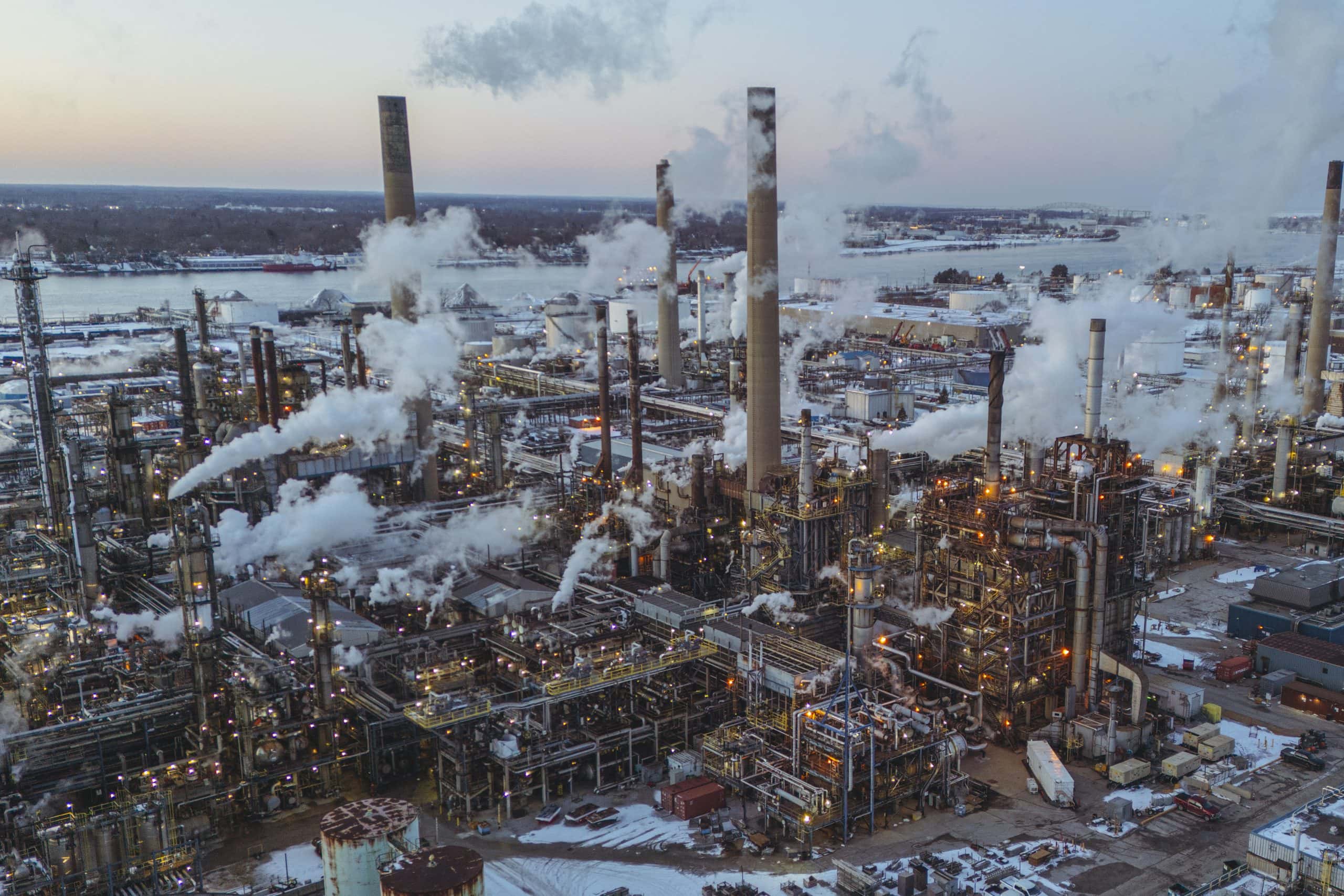 Smoke rises from factories and stacks in Sarnia's chemical valley under a setting sun