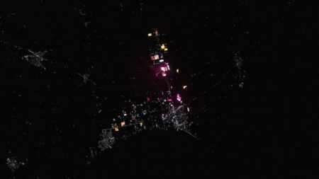 Bright Greenhouse Lights Shine Through the Night Sky