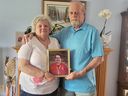 Lorraine and Derk Sherren hold a photo of their late son, Robbie, inside their family home in Kingston on Saturday, May 18, 2024. Robbie, who died recently became the first adult heart donor in Canada to donate after circulatory death which happens when a person's heart permanently stops beating.