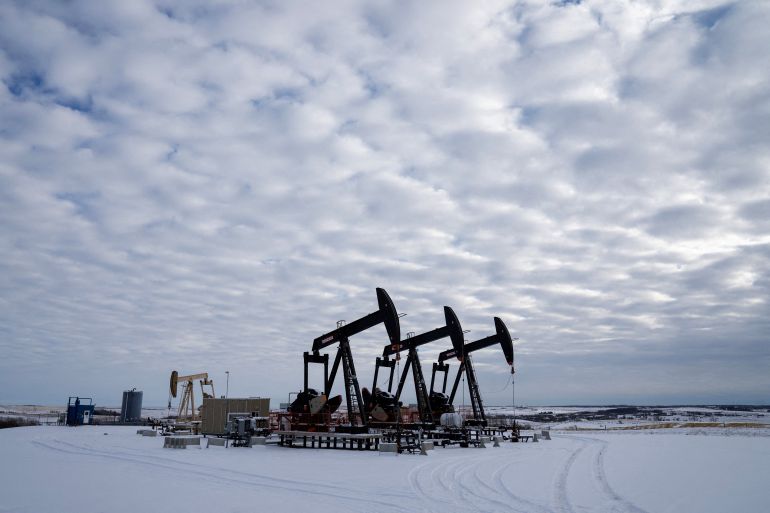 FILE PHOTO: Oil pumpjacks operating in a farmer’s field near Calgary, Alberta, Canada on November 26th ,2025. REUTERS/Todd Korol/File Photo
