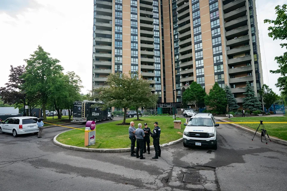 Investigators work the scene where a Toronto Police Officer was shot in Toronto on Thursday, June 11, 2026. THE CANADIAN PRESS/Arlyn McAdorey