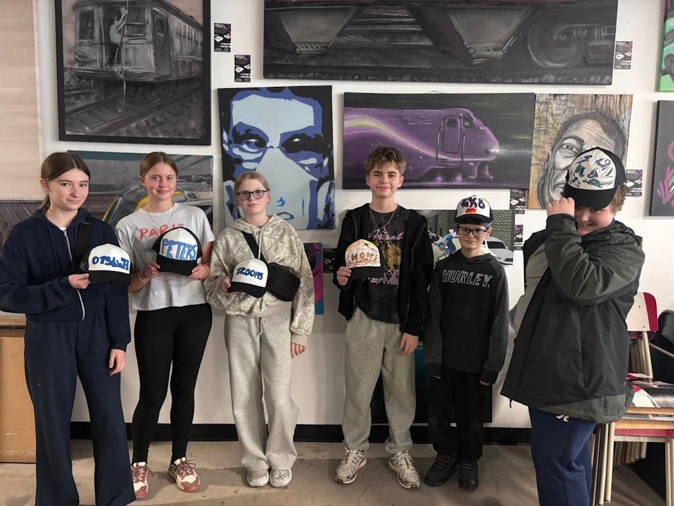 Students show off hats they created during a visit to Café Graffiti in Montreal, part of a hands-on experience exploring the city’s arts scene. Submitted Photo/Mark Sokolowski