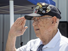 Casey Bukowski age101of Lancaster NY salutes during aceremonyatthe40thanniversarycelebrationofthe Canadian Harvard Aircraft Associationon Saturday.