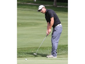 A man golfing on a putting green