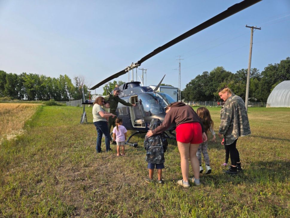 Staff and children explore and ask questions about the helicopter that visited the centre on Tuesday. Photo/Portage Online Brittany Boschman
