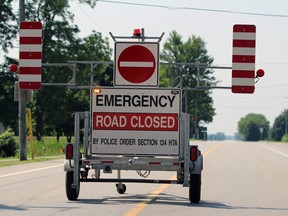 A police road closed sign