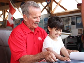 Chris Hadfield shows a book to a child