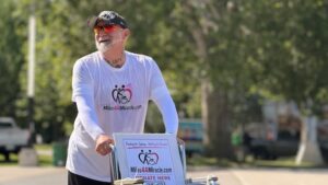 London father pushes daughter’s wheelchair 200 kilometres to advocate for access to health care