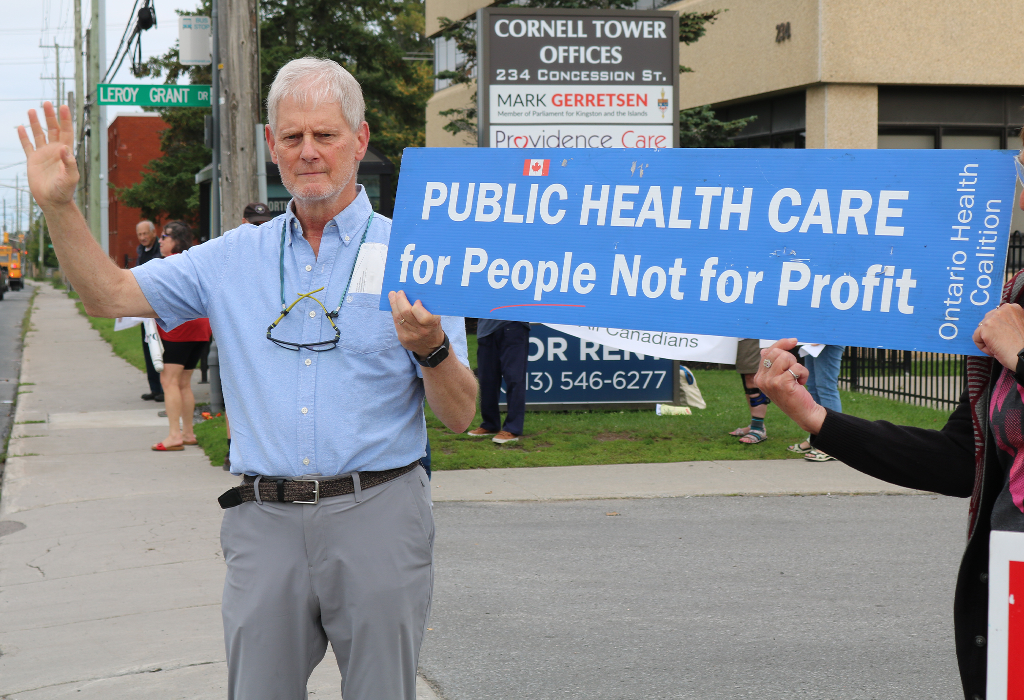 A man holding a blue sign