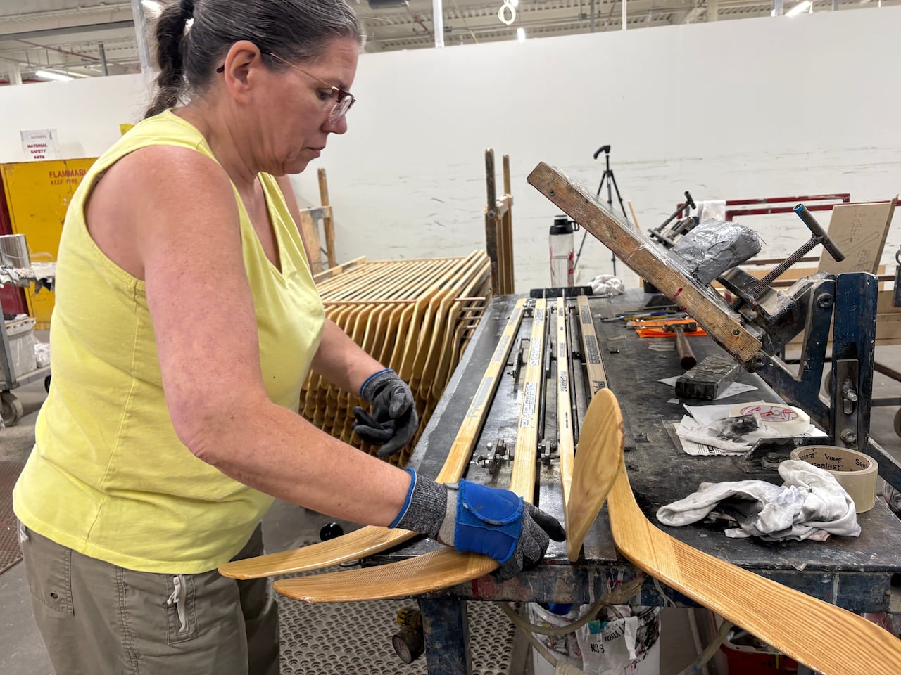A worker makes wooden hockey sticks at Roustan Hockey.