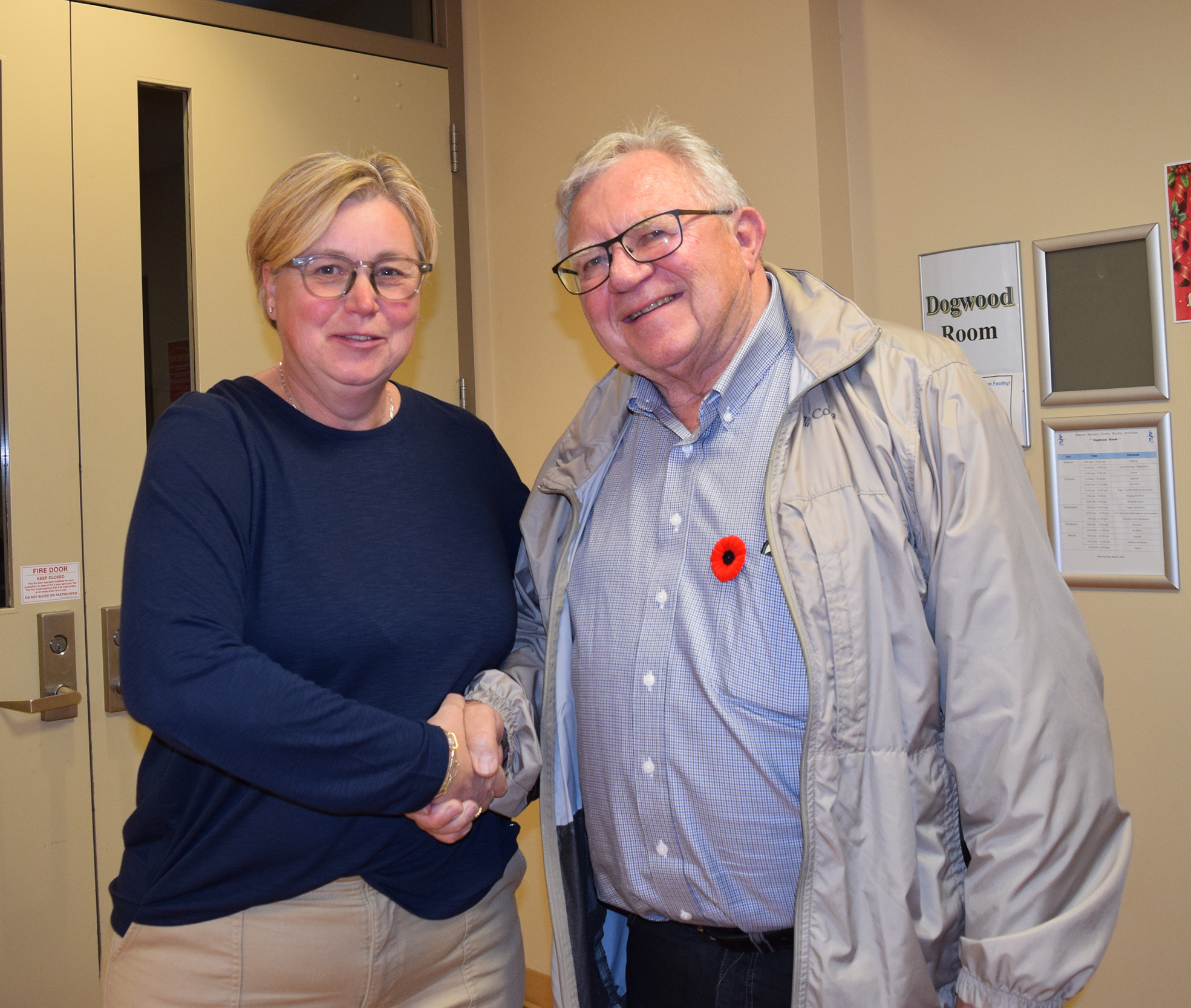 Man shaking woman's hand after her election win
