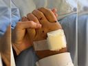 Ashley Smith, the wife of Const. Jeff Smith, shares a photo of his wounded hand alongside a heartfelt message.