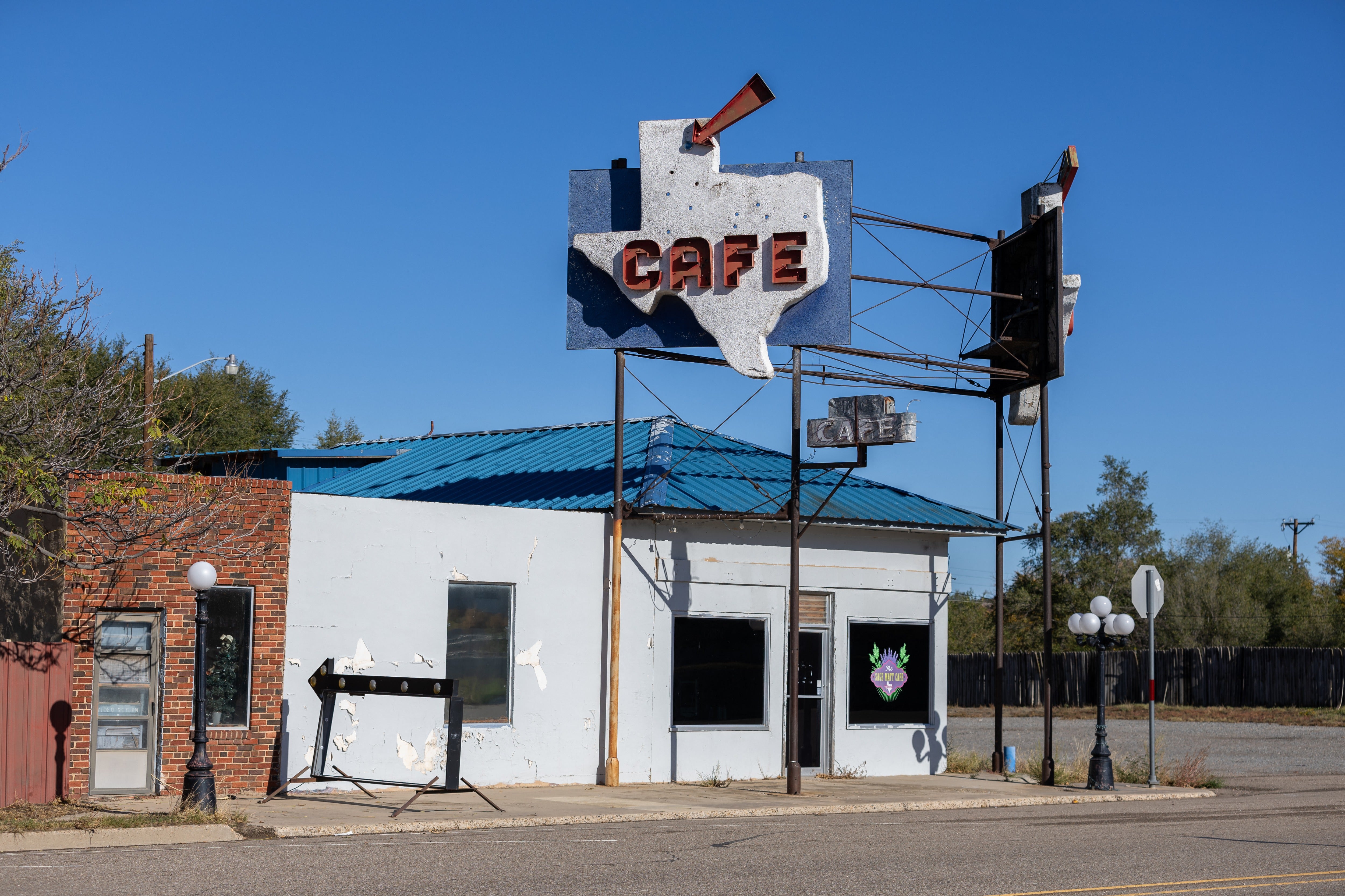 An arrow points to the location of the town of Miami, Texas, on a cafe sign on Election Day, November 5, 2024. This speck of a town of around 500 souls -- a world away from its glamorous sister in Florida - is known as the most vehemently pro-Trump town in the U. S.: 96 percent of its voters backed the Republican in the 2020 election
