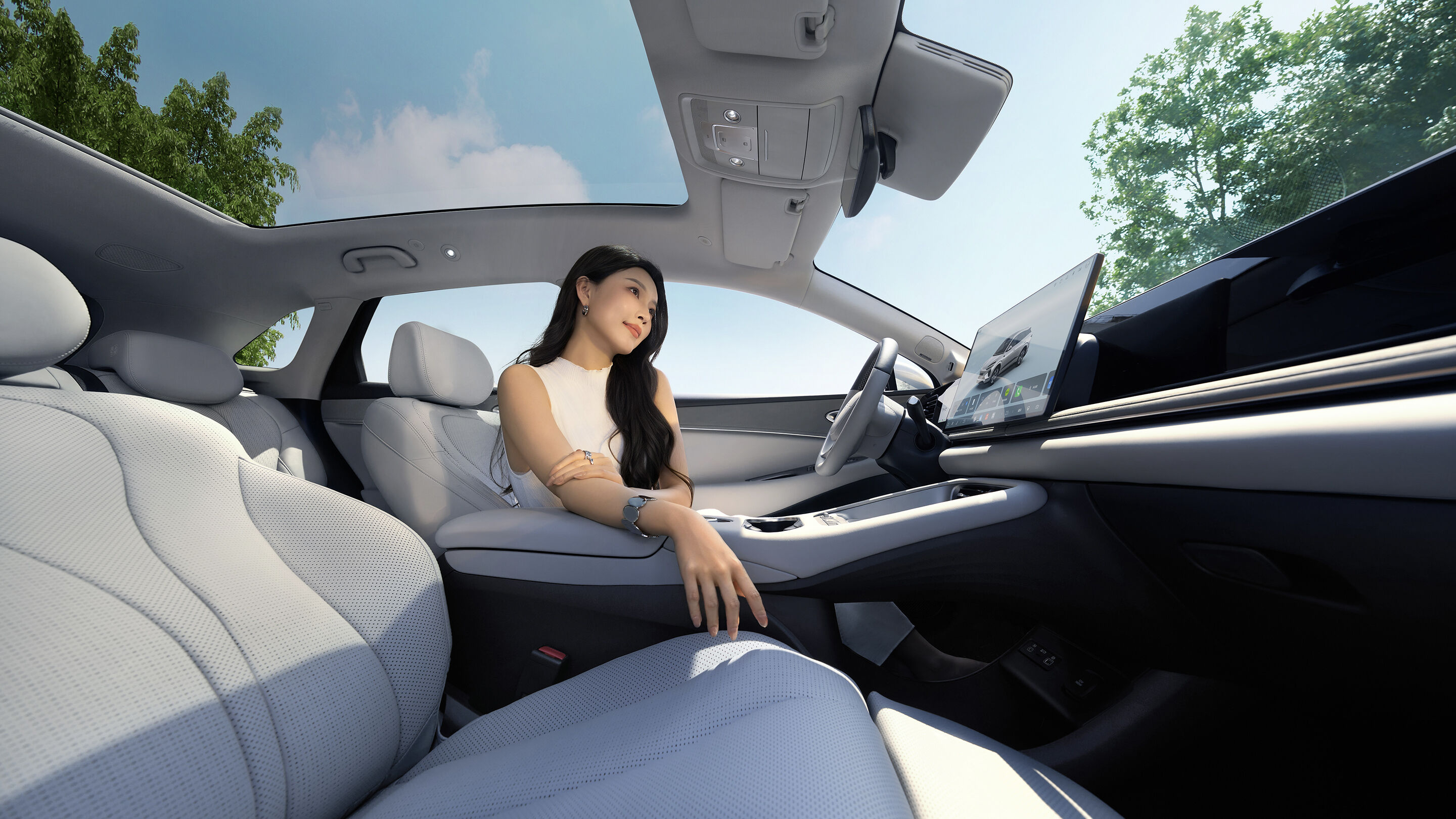 Cabin of the %2026% BYD Sealion %0606% EV with a passenger seat glass roof and tilted central display in an official image